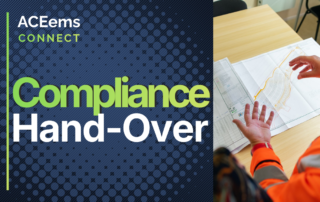 Engineers looking over papers captioned "Compliance hand-over"